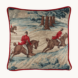 Photo of a linen cushion with a classic English hunting scene of horses and riders and hounds in blue, red, brown and taupe