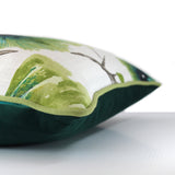 Side view of floral cushion featuring large scale exotic flowers in a bright gooseberry colour on a white background with an emerald velvet back