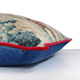 Side view of a linen cushion with a classic English hunting scene of horses and riders and hounds in blue, red, brown and taupe, scarlet red velvet piping and a blue velvet back