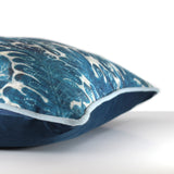 Side view of a cushion in a watery damask design in an elegant cobalt and white colour with powder blue cotton piping and a navy velvet back