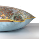 Side view of a cushion made from a vintage printed cotton with a Persian pictorial scene of riders in a forest in a colour palette of lemon, clementine, brown, mint. and powder blue