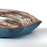 Photo of a cushion made from a printed linen with natural coloured native american indian feather headdresses, rust linen piping and a petrol coloured back