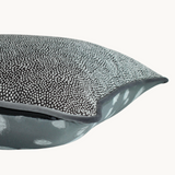 Side shot of an achromatic piped cushion cushion 