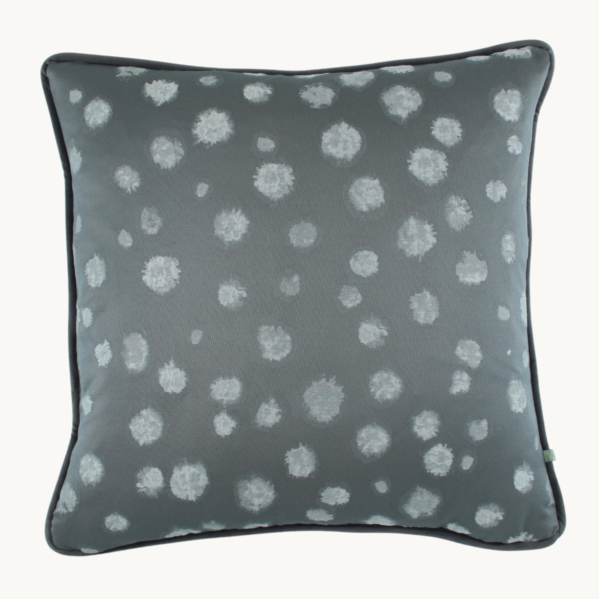 Photo of a cushion with a large scale pewter mottled spot design