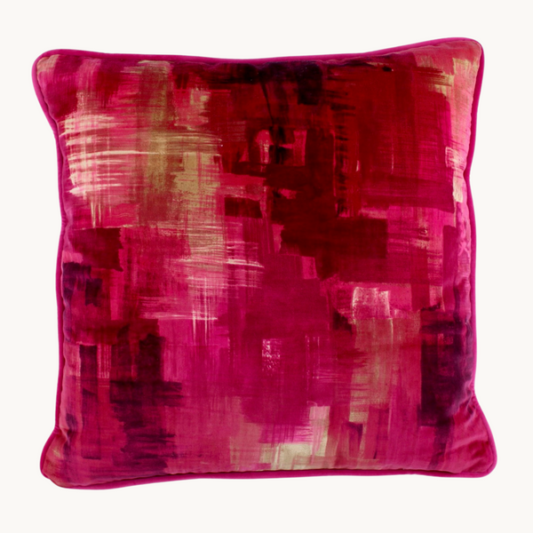 Photo of a velvet cushion in vibrant shades of pink and rich burgundy