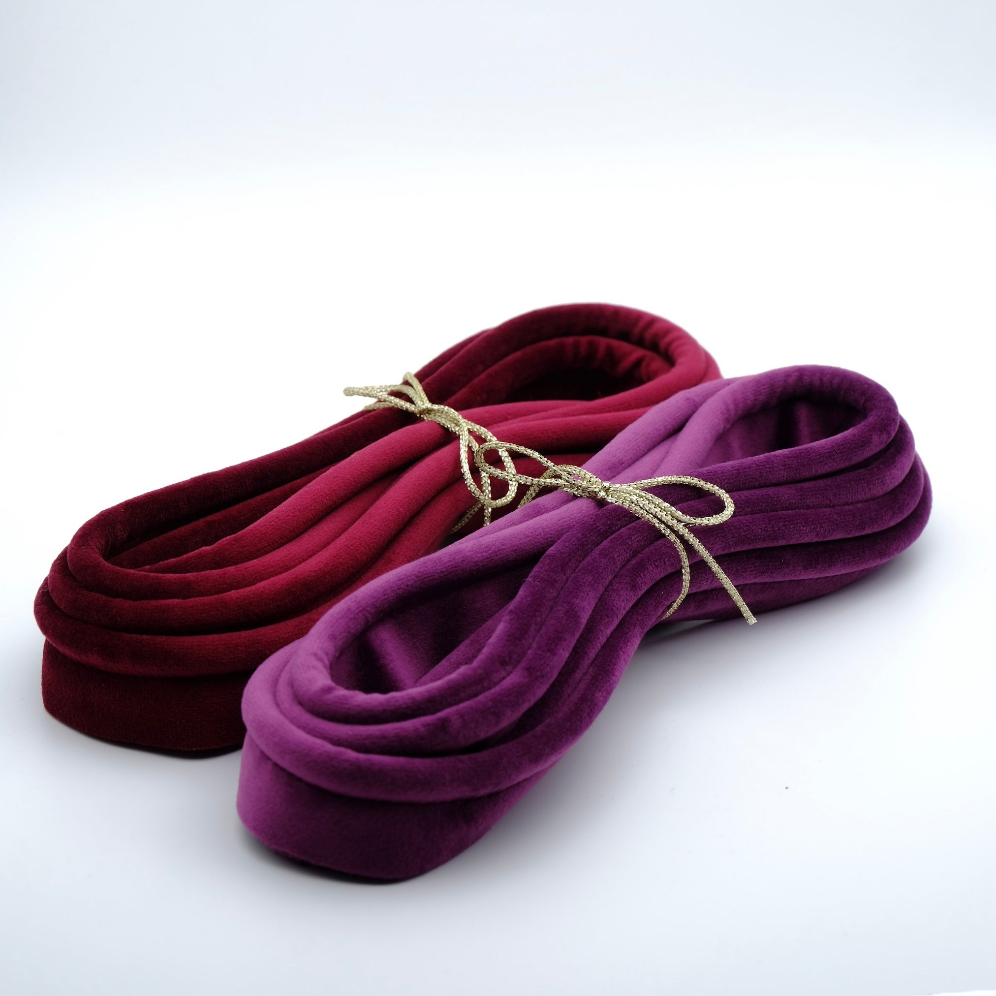 Photo of two bundles of purple and berry velvet piping cord
