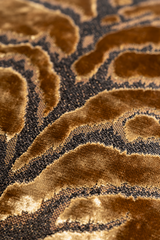 Close up of a lustrous bronze coloured velvet with a tiger pattern