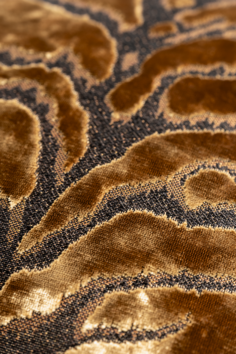 Close up of a lustrous bronze coloured velvet with a tiger pattern