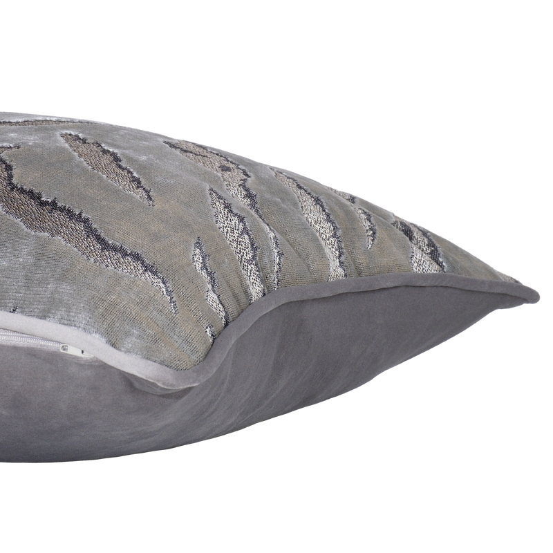 Side shot of a decorative cushion in a shiny silver velvet with a tiger stripe pattern