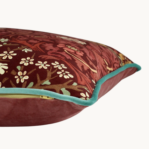 Side shot of a cushion made from a William Morris fabric from 2002 in russet tones with mint accents