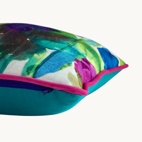 Side shot of a brightly coloured floral cushion with painterly brushstrokes