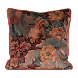 Decorative velvet pillow with a traditional floral pattern in pinks and deep reds