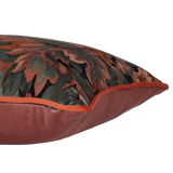 Side photo of a decorative cushion with a tradtional floral pattern on velvet