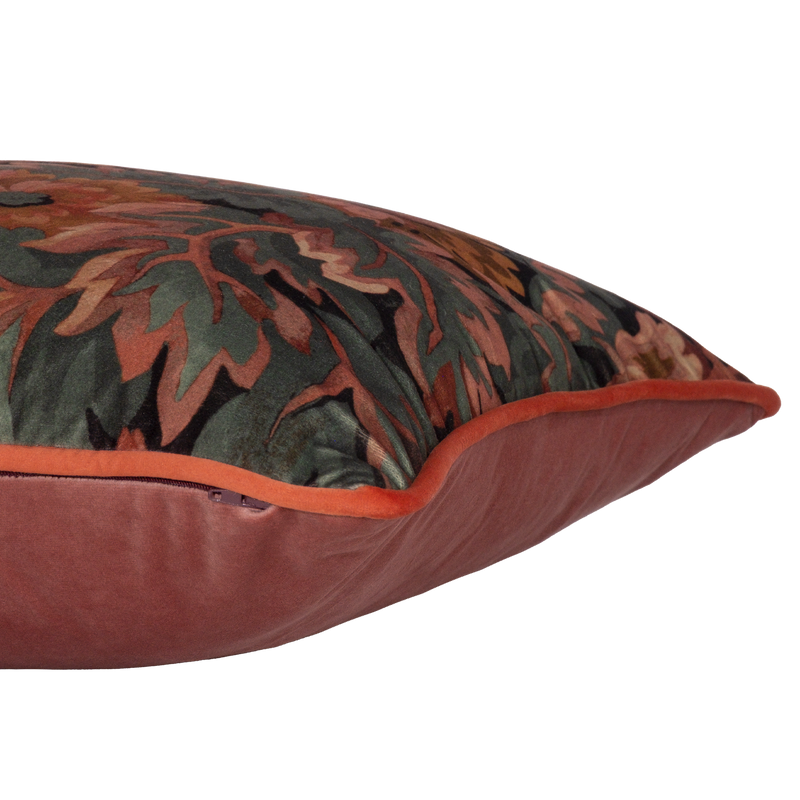 Side photo of a decorative cushion with a tradtional floral pattern on velvet