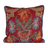 Linen cushion in a rich red with blue and green large scale scrolled design