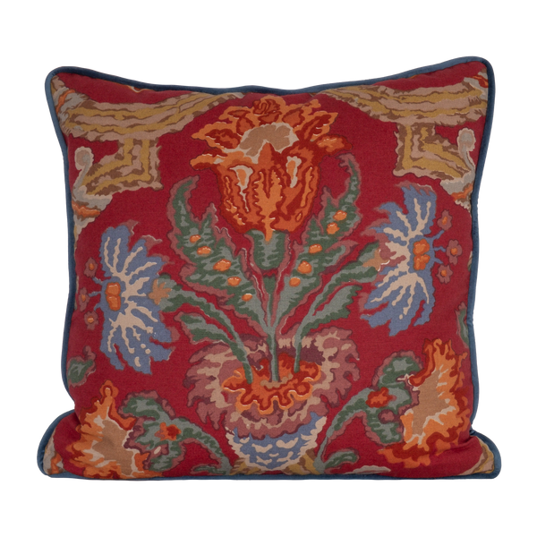 Linen cushion in a rich red with blue and green large scale scrolled design