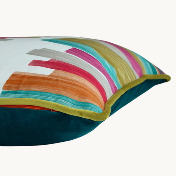 Side shot of a brightly coloured cushion with painterly brushstroke lines