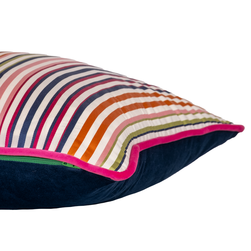Side shot of a decorative cushion with a crisp white background and narrow multicoloured stripe