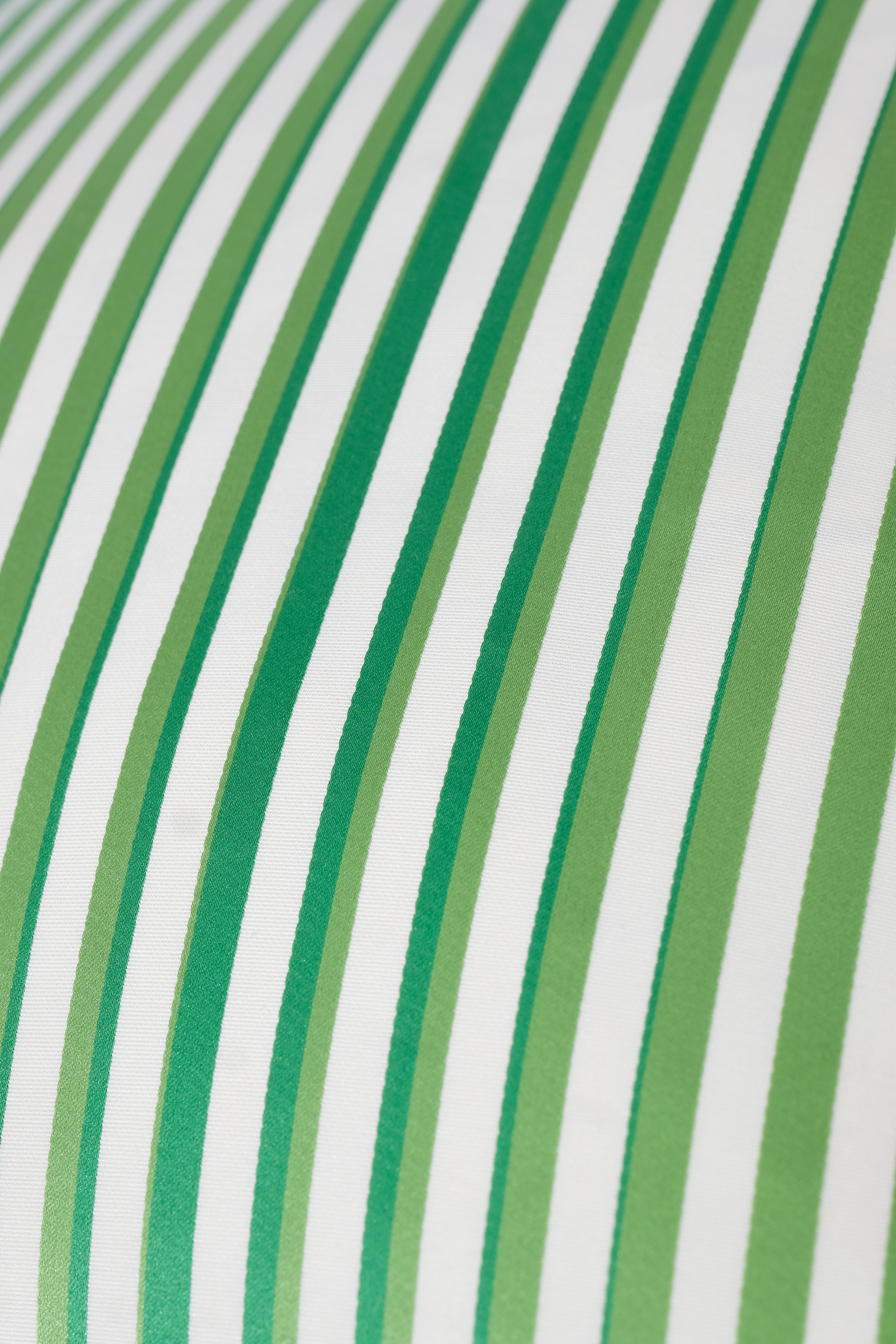 Close-up of green and white regency striped sateen fabric
