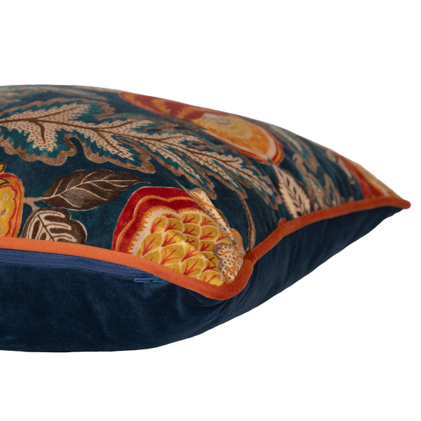 Decorative pillow with floral and fruit pattern on a dark blue background