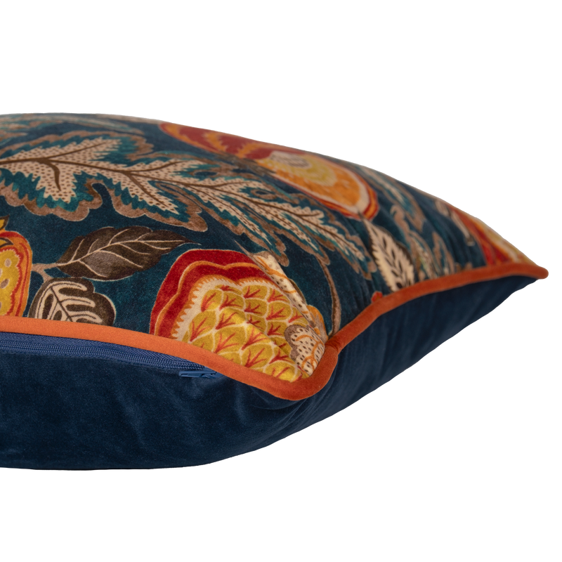 Decorative pillow with floral and fruit pattern on a dark blue background