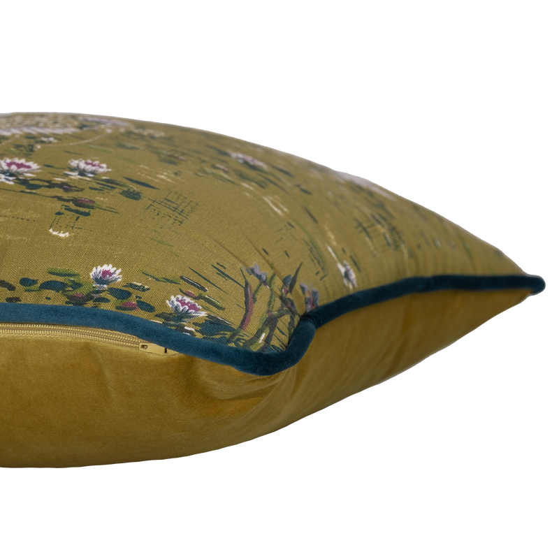 Side shot of a cushion with white swans and flowers on an olive coloured base