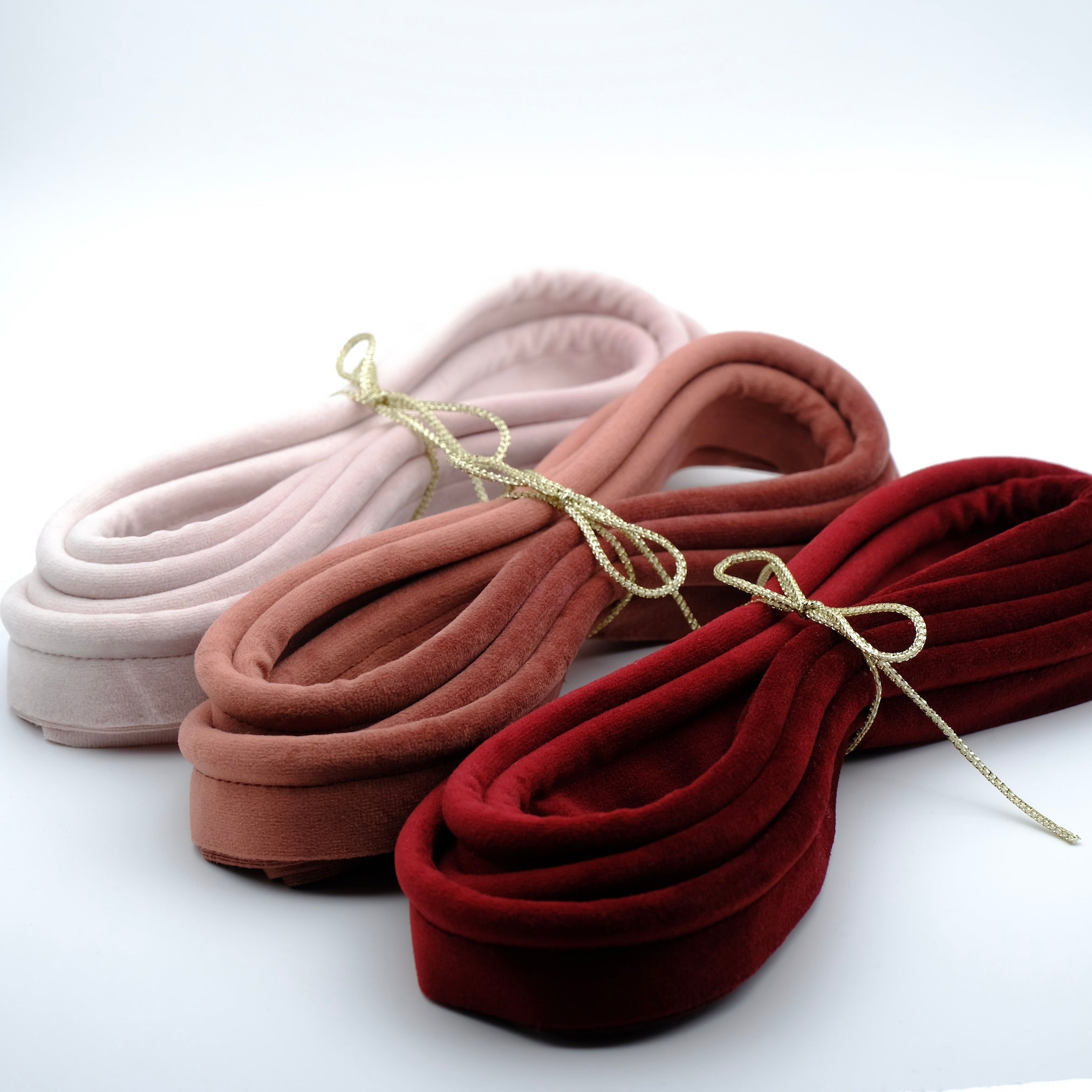 Photo of three bundles of velvet piping in warm tones
