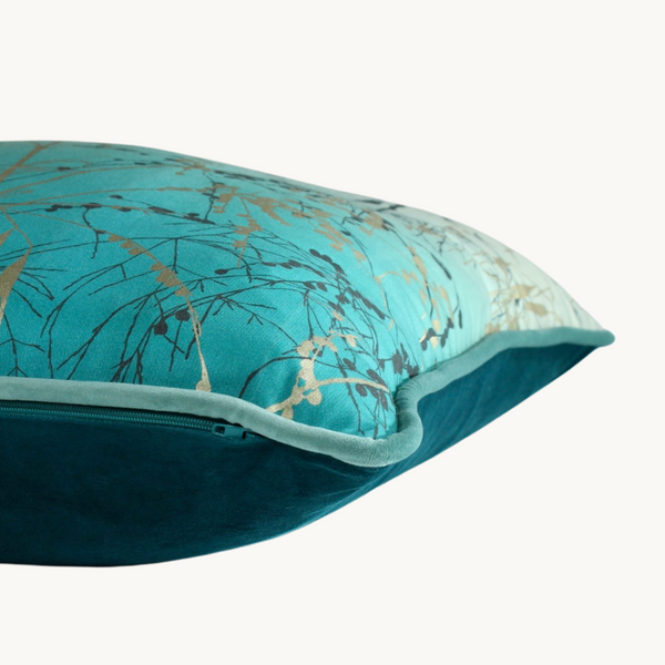 Side shot of a botanical cushion in turquoise and silver