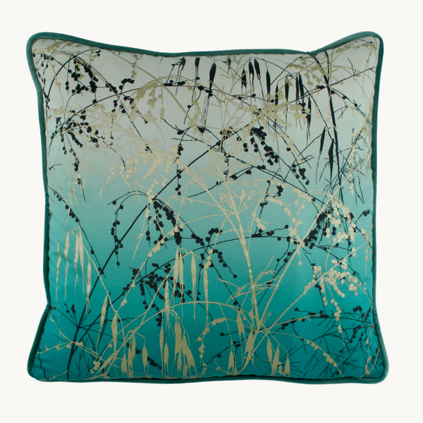 Photo of a botanical cushion in teal and silver with wispy seedheads