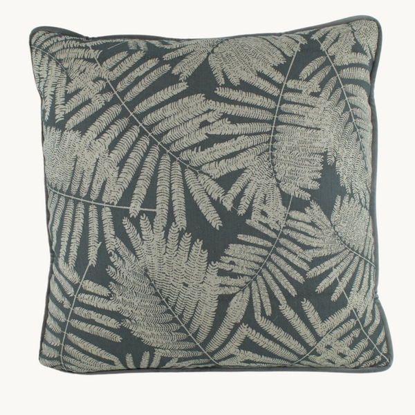 Photo of a grey cushion with silver coloured ferns on the front.