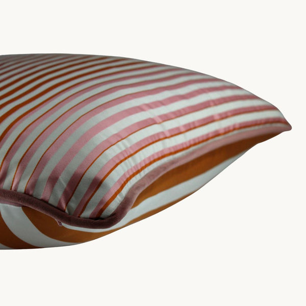 Side shot of a striped cushion in orange and pink