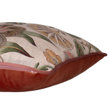 Side shot of a linen floral cushion in pinks greens and natural tones.