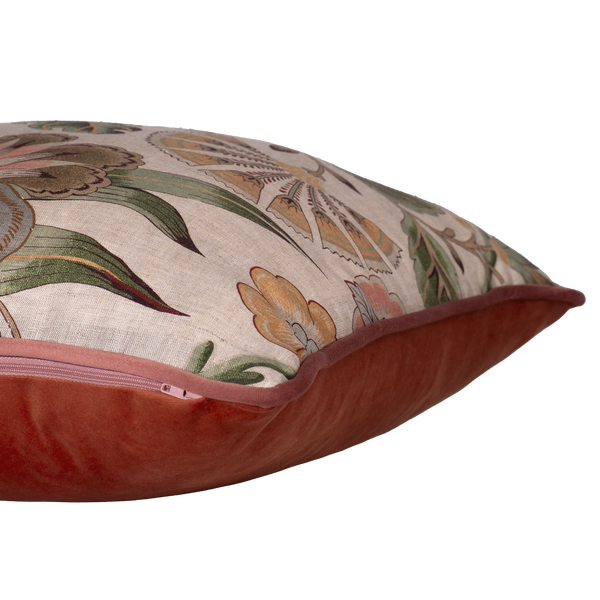 Side shot of a linen floral cushion in pinks greens and natural tones.