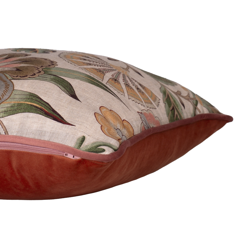 Side shot of a linen floral cushion in pinks greens and natural tones.