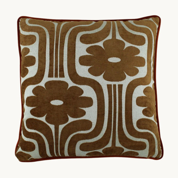 photo of a cushion with a retro cut velvet large scale floral design in a rich tan colour