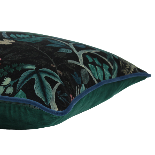 Decorative cushion with a leafy  botanical pattern on a black velvet background