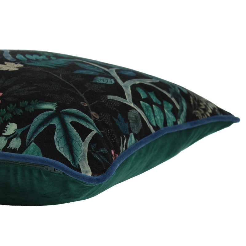 Decorative cushion with a leafy  botanical pattern on a black velvet background