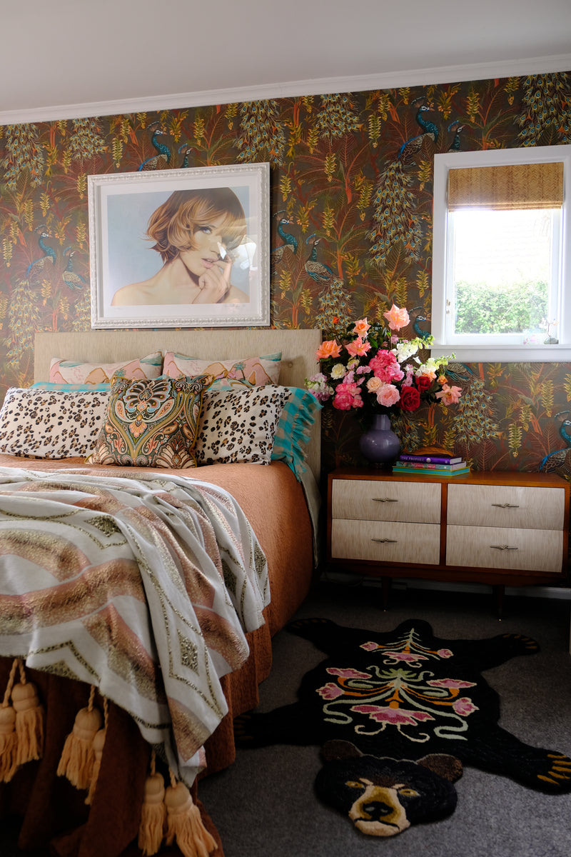 Photo of a bedroom with wallpaper and decorative elements