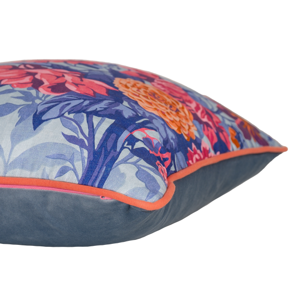 Floral patterned cushion with  pink, coral and orange dahlias on a light blue background