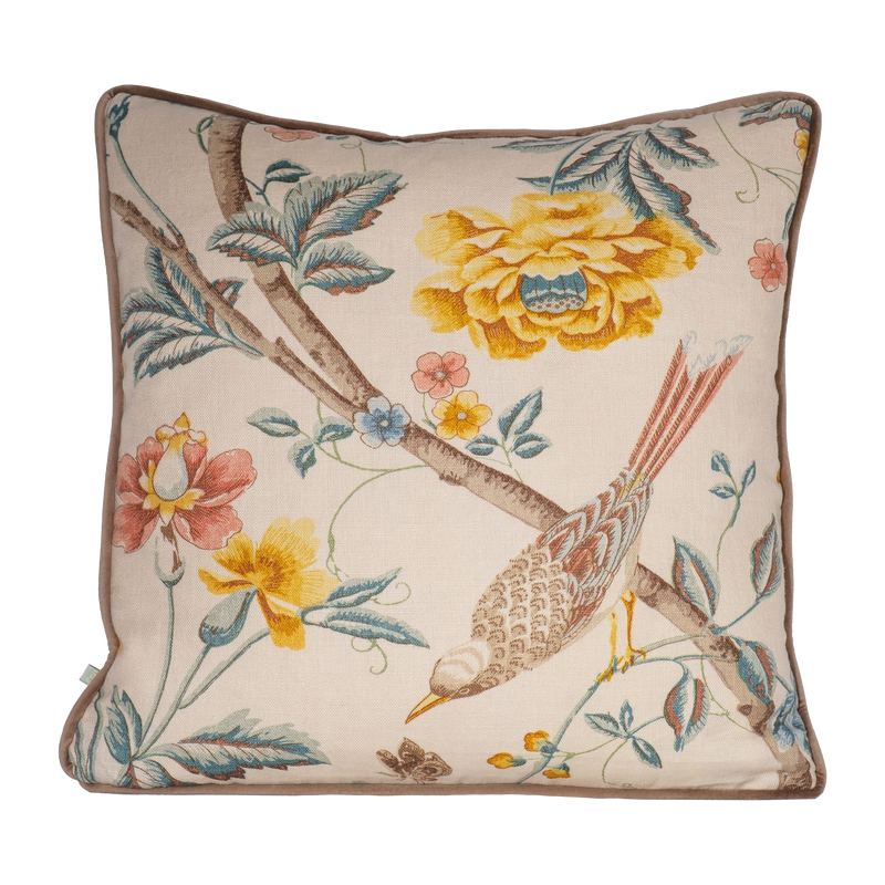 Decorative cushion with floral and bird design on a linen background