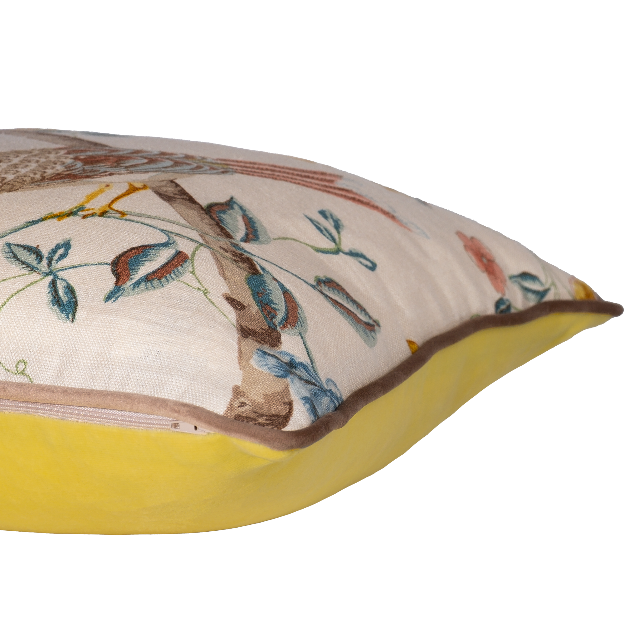 Side view of a decorative cushion with floral and bird design on a linen background