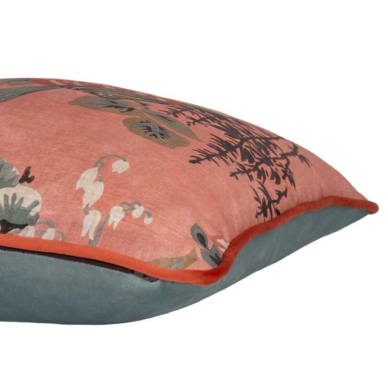 Side shot of a decorative linen cushion with a large boquet of flowers in salmon, red, duck egg blue and rich brown.