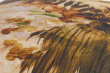 Close up of a fabric featuring an impressionist style painting of a forest scene in natural colours
