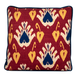 Cushion with an ikat pattern in a deep russet colour with navy and yellow accents