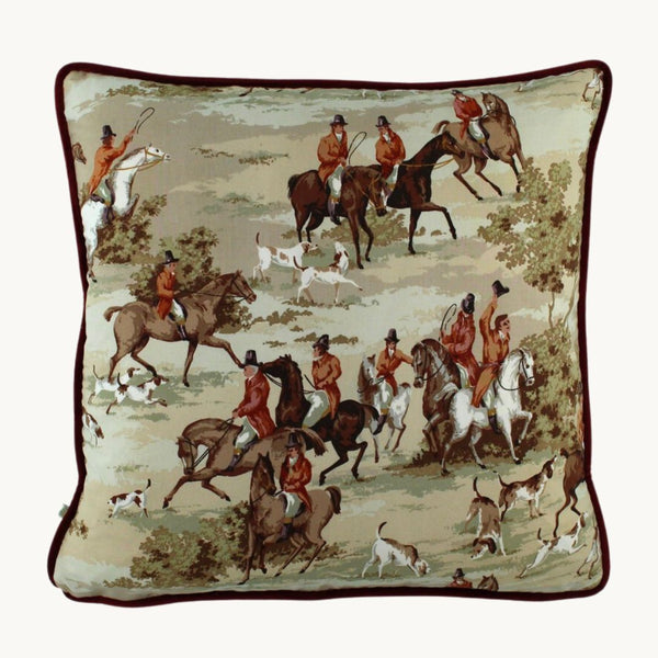 Photo of a cushion made from a vintage fabric depicting an English hunting scene with horses and hounds