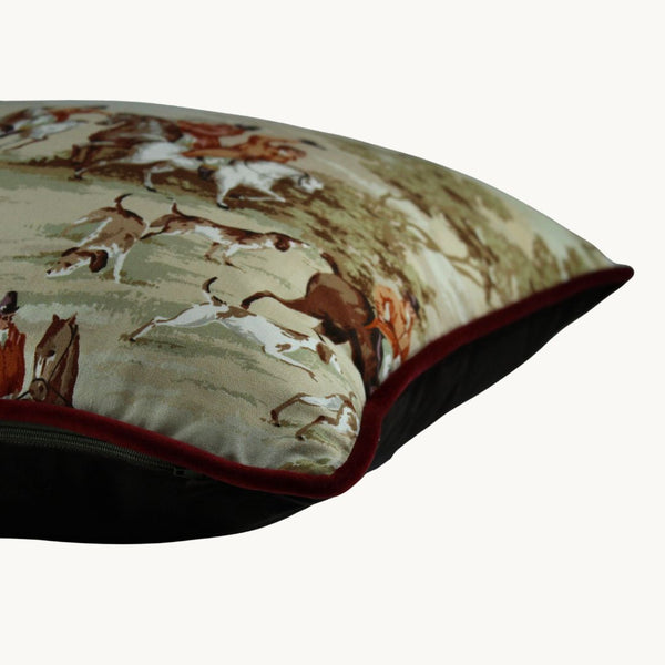 Side photo of a cushion made from a vintage fabric depicting an English hunting scene with horses and hounds
