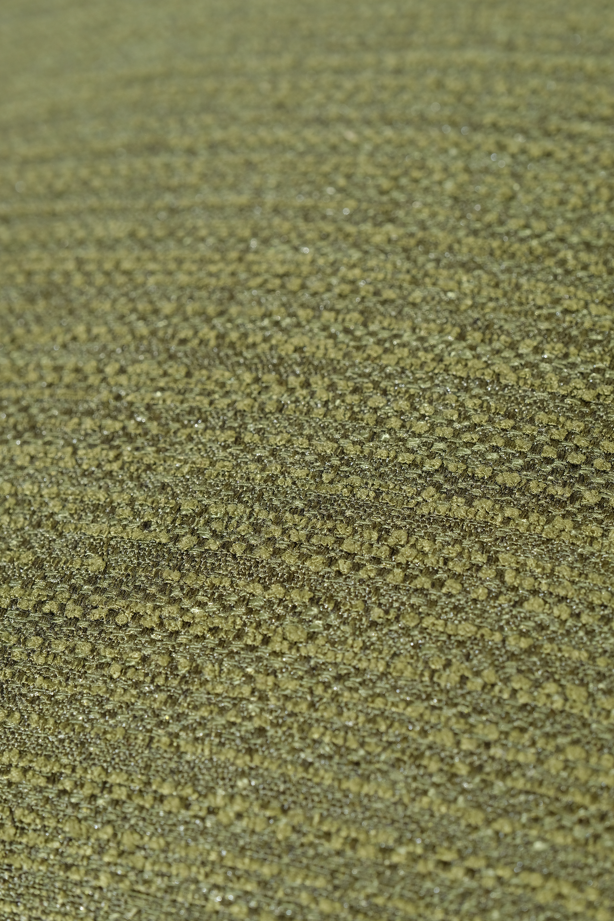 A close-up of a textured woven fabric in an olive green colour