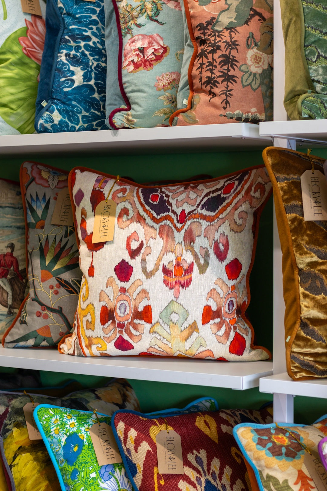 Colorful patterned cushions on a shelf in a shop