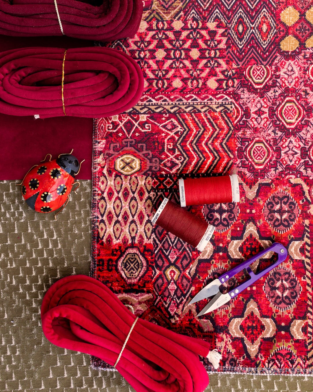 Flatlay of persian patterned velvet and other sewing elements.