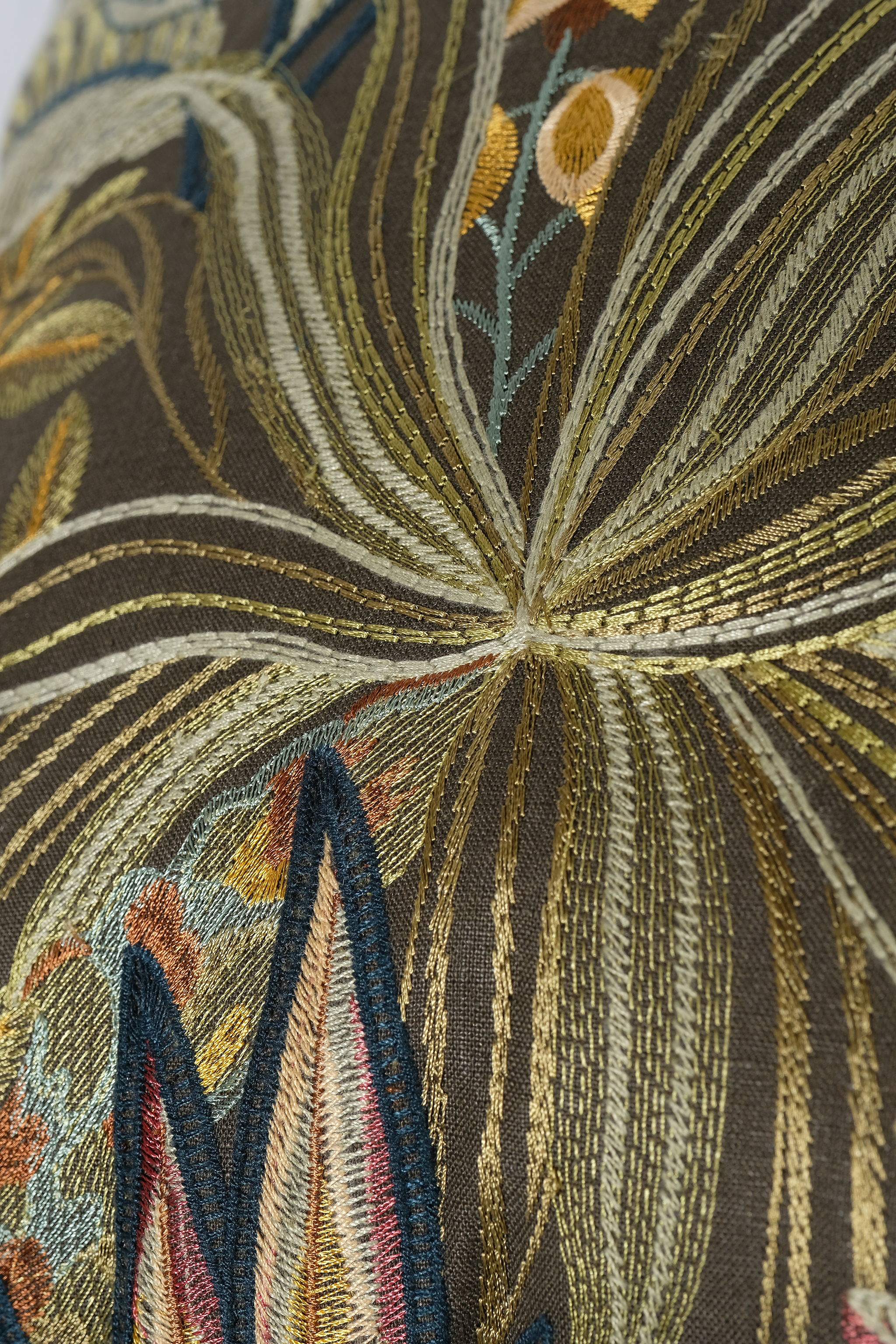 Close-up of an embroidered cushion with a jungle design